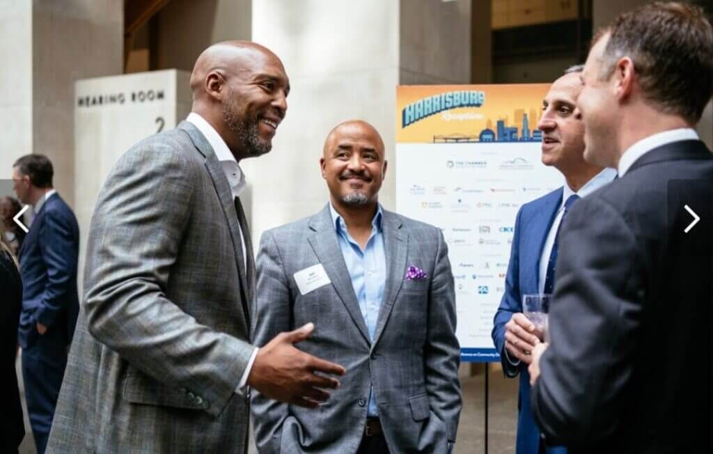 Business and civic leaders in conversation at a regional reception